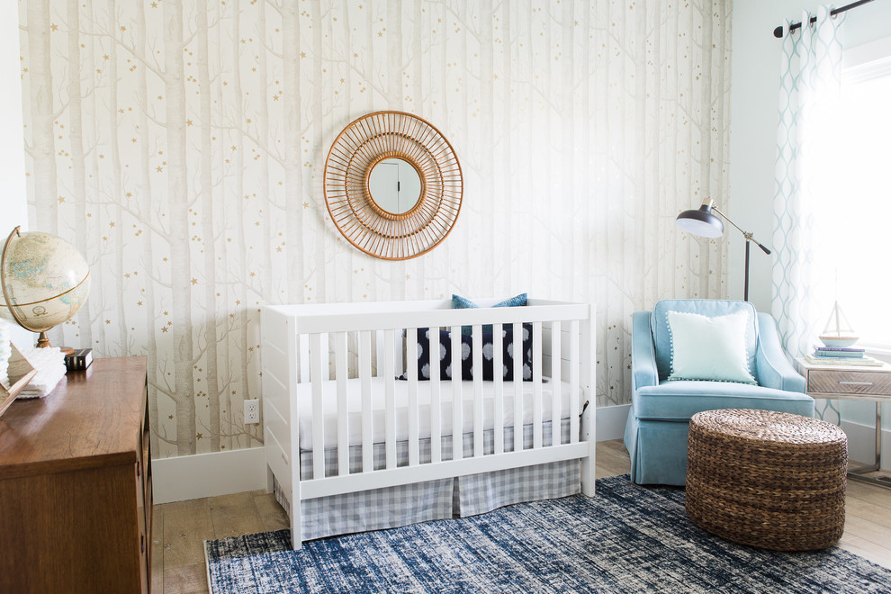 This is an example of a transitional gender-neutral nursery in Salt Lake City with light hardwood floors and beige walls.