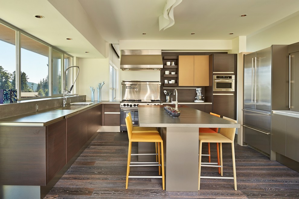 This is an example of a contemporary u-shaped kitchen in Seattle with flat-panel cabinets, dark wood cabinets, stainless steel appliances, dark hardwood floors and with island.