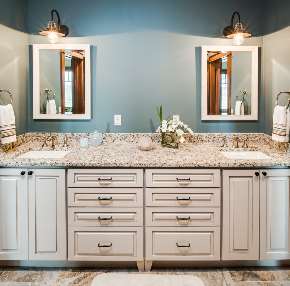 Design ideas for a traditional kids bathroom in Other with raised-panel cabinets, white cabinets, blue walls, an undermount sink, granite benchtops and brown floor.