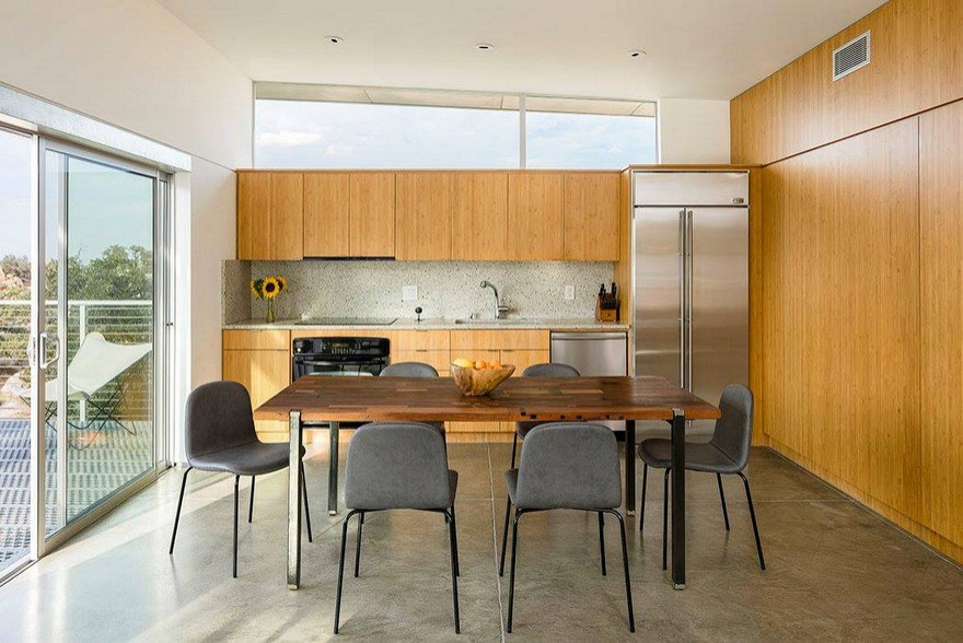 Inspiration for a small contemporary single-wall eat-in kitchen in Charleston with an undermount sink, flat-panel cabinets, medium wood cabinets, granite benchtops, beige splashback, granite splashback, stainless steel appliances, concrete floors, no island, grey floor and beige benchtop.