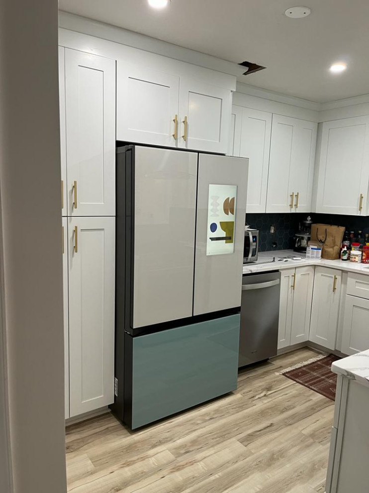 Inspiration for a small traditional u-shaped enclosed kitchen in Philadelphia with shaker cabinets, white cabinets, engineered stone countertops, blue splashback and white worktops.