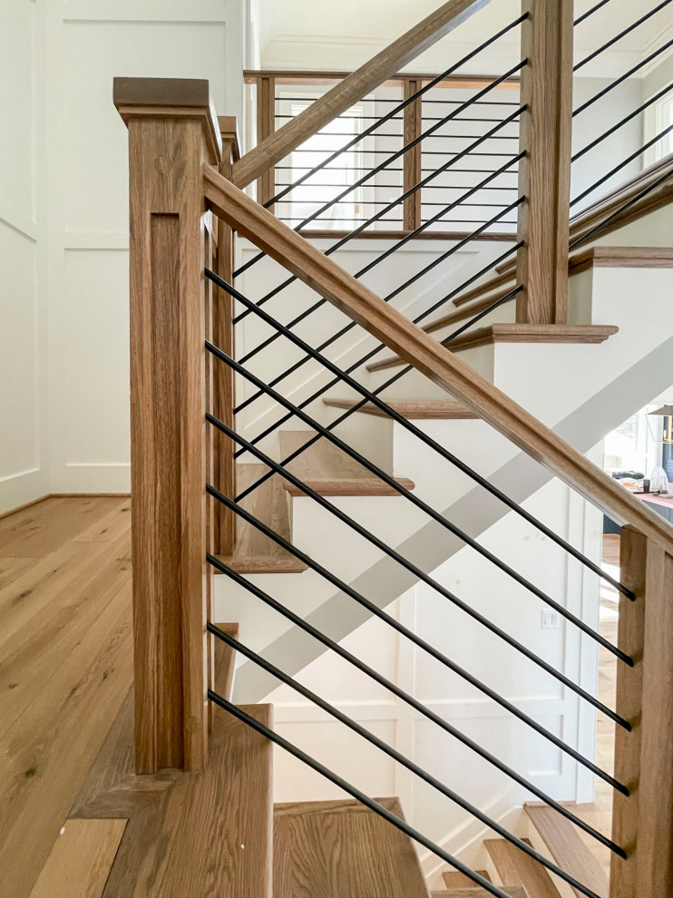 Ejemplo de escalera suspendida retro grande con escalones de madera, contrahuellas de madera y barandilla de varios materiales