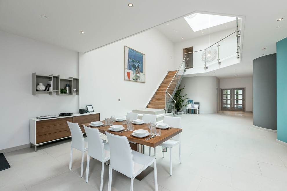 This is an example of a contemporary dining room in Glasgow with white walls and no fireplace.