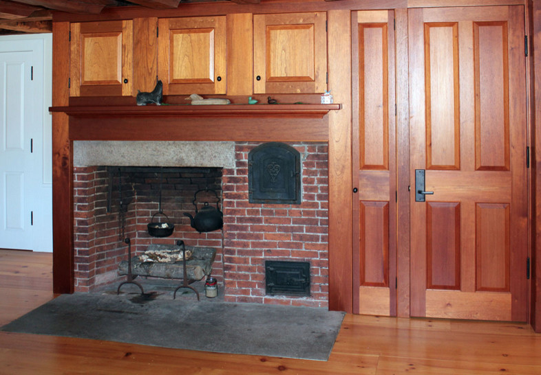Design ideas for a mid-sized transitional enclosed family room in Boston with medium hardwood floors, a standard fireplace and a brick fireplace surround.