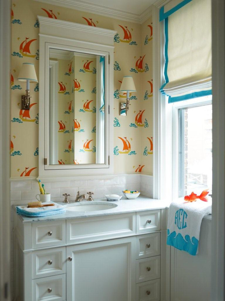 Inspiration for a small traditional kids bathroom in New York with an undermount sink, flat-panel cabinets, white cabinets, marble benchtops, a shower/bathtub combo, a two-piece toilet, gray tile, multi-coloured walls and marble floors.