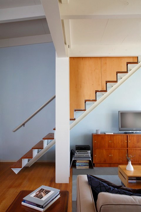 This is an example of a midcentury wood floating staircase in San Francisco with metal risers.