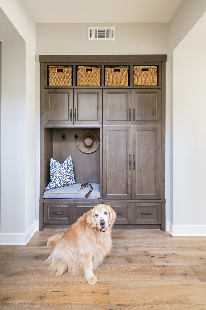Photo of a beach style mudroom in San Diego with grey walls, light hardwood floors and beige floor.