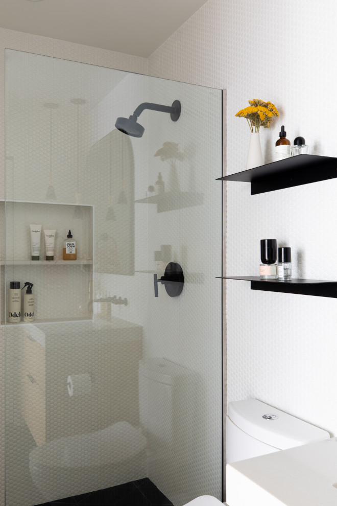 This is an example of a small scandinavian ensuite bathroom in San Francisco with flat-panel cabinets, light wood cabinets, an alcove shower, white tiles, ceramic tiles, white walls, porcelain flooring, a submerged sink, engineered stone worktops, black floors, an open shower, white worktops, a wall niche, a single sink and a floating vanity unit.