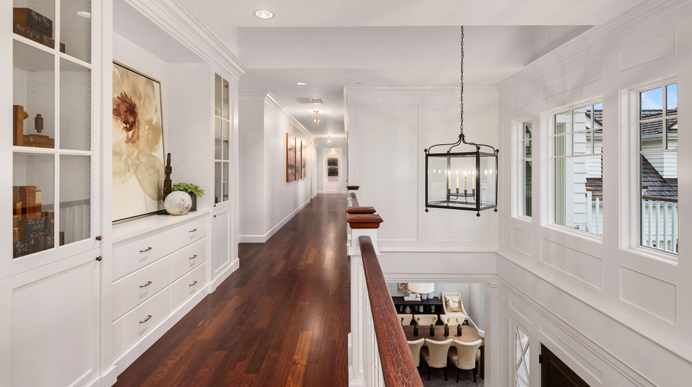 Inspiration for a large traditional hallway in Seattle with white walls, dark hardwood floors and brown floor.