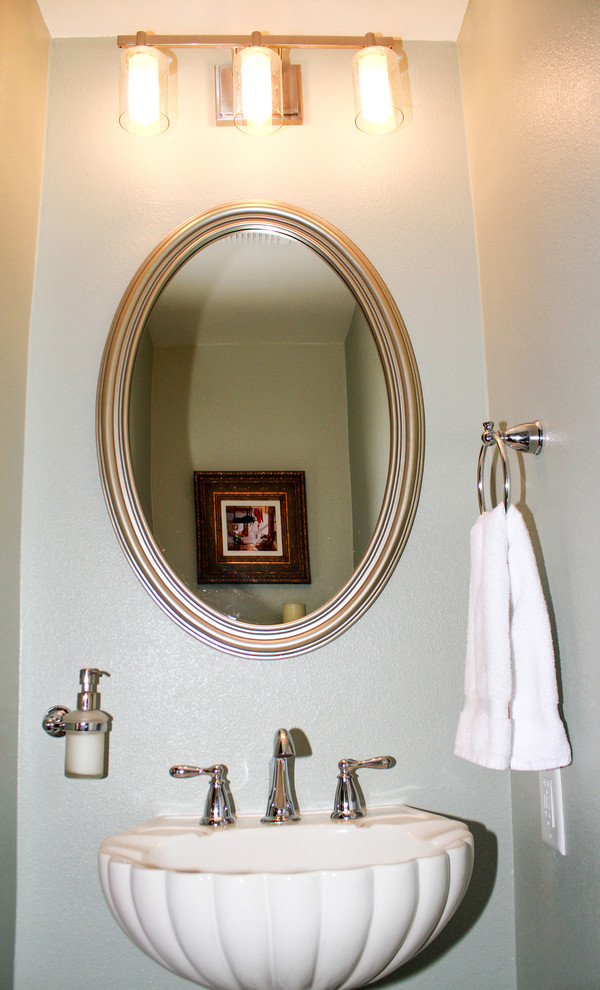 Inspiration for a small transitional 3/4 medium tone wood floor and brown floor bathroom remodel in Orange County with a one-piece toilet, green walls and a pedestal sink