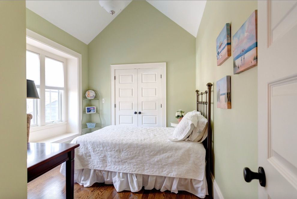 Large transitional guest bedroom in Boston with green walls and medium hardwood floors.