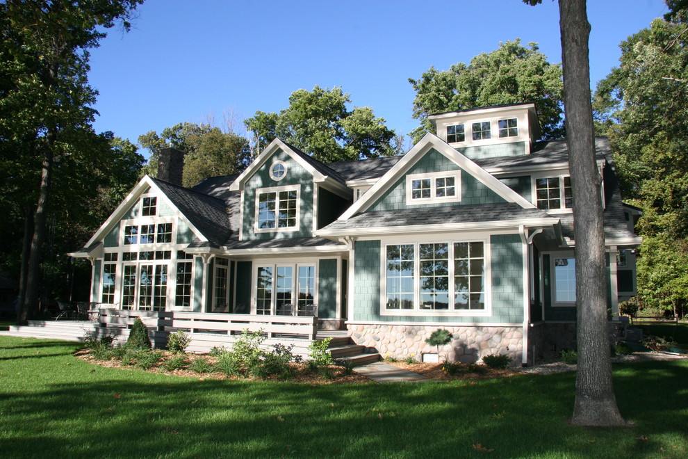 Traditional two-storey green exterior in Other with wood siding.