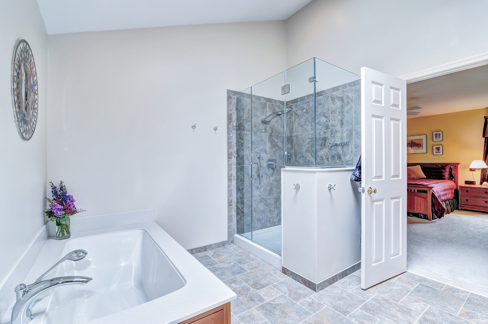 Bathroom - large modern master gray tile and stone tile ceramic tile bathroom idea in Philadelphia with a console sink, recessed-panel cabinets, medium tone wood cabinets, quartz countertops, a one-piece toilet and beige walls