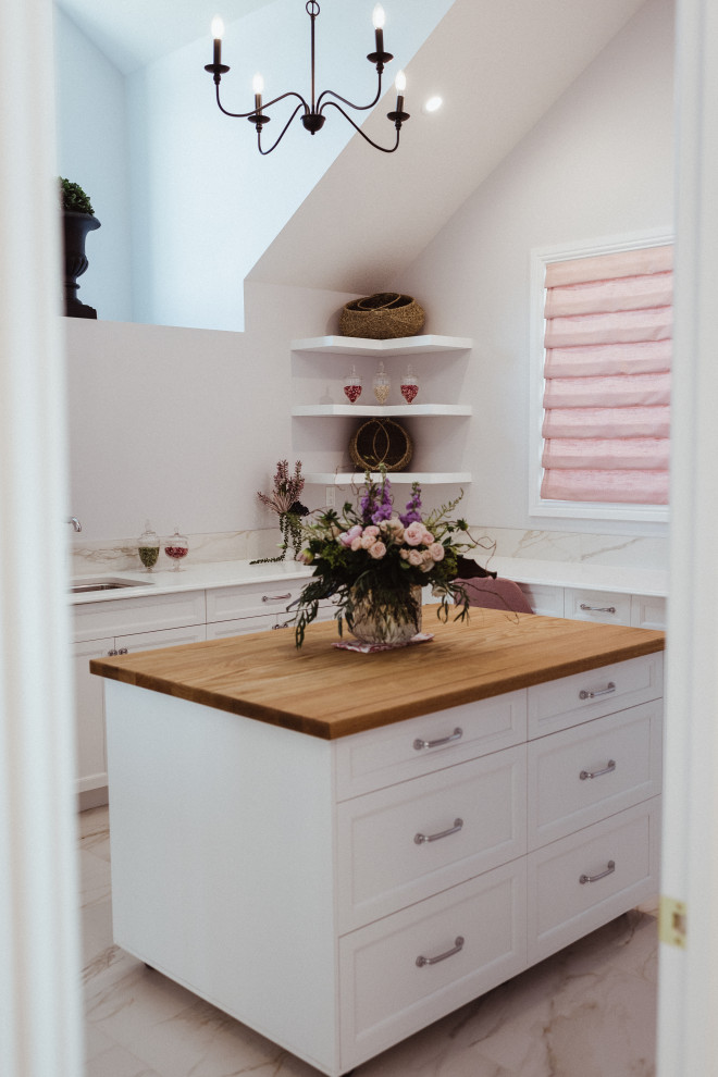 Inspiration for a large traditional u-shaped utility room in Edmonton with an undermount sink, shaker cabinets, white cabinets, quartz benchtops, white splashback, porcelain splashback, grey walls, porcelain floors, a side-by-side washer and dryer, grey floor, white benchtop, vaulted and wallpaper.
