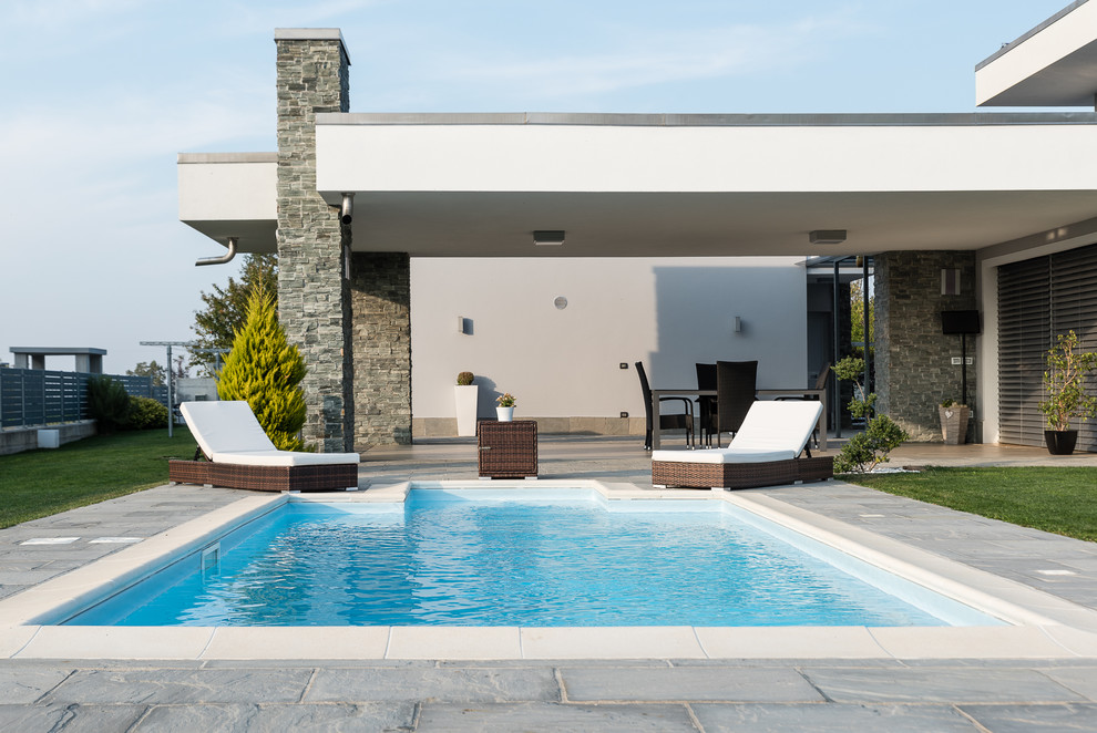 Large transitional backyard rectangular lap pool in Turin.
