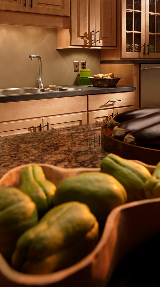 Example of a large mountain style slate floor and gray floor enclosed kitchen design in Chicago with a double-bowl sink, raised-panel cabinets, medium tone wood cabinets, granite countertops, gray backsplash, slate backsplash, stainless steel appliances and an island