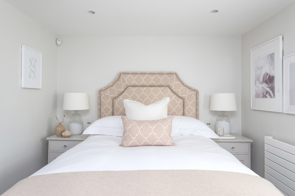 Photo of a transitional master bedroom in London with white walls.