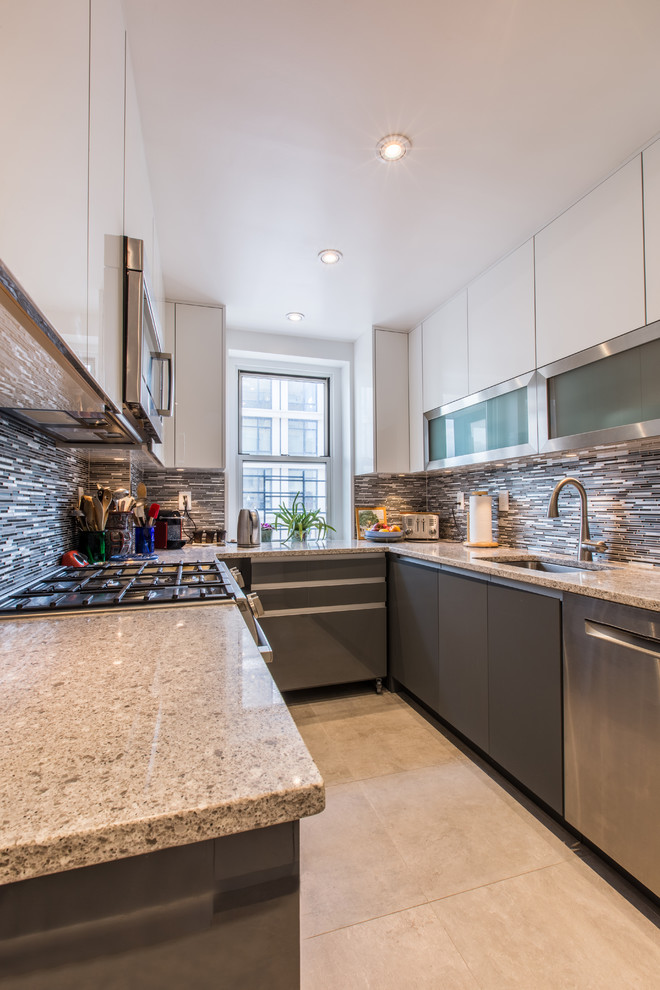 Photo of a small modern u-shaped separate kitchen in New York with an undermount sink, flat-panel cabinets, grey cabinets, granite benchtops, grey splashback, matchstick tile splashback, stainless steel appliances, ceramic floors and no island.