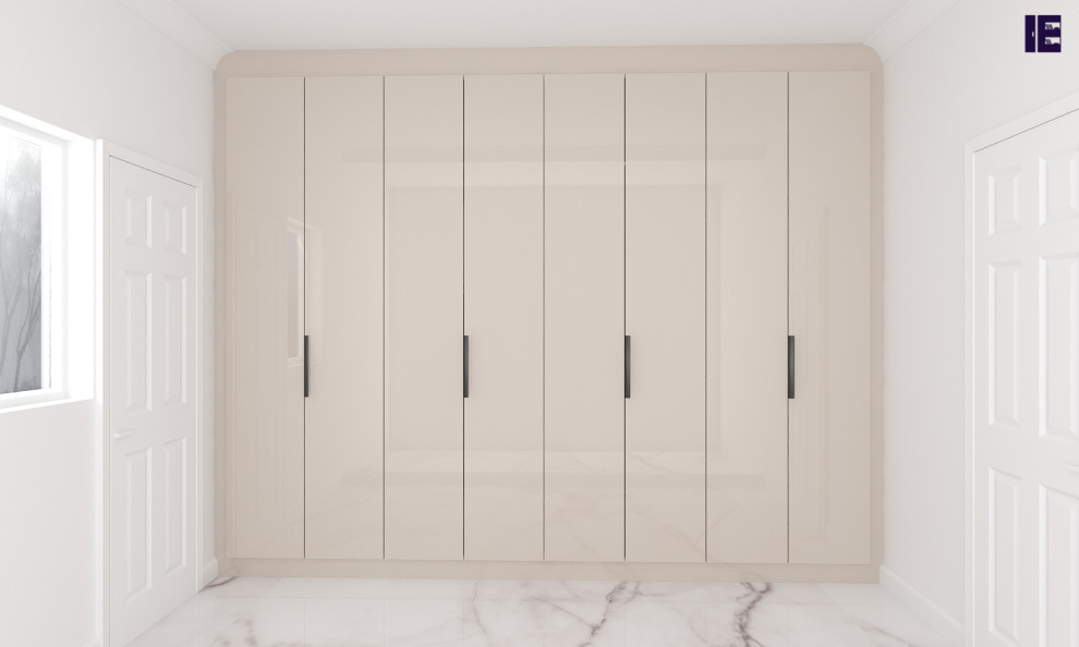 This is an example of a large modern built-in wardrobe in London with flat-panel cabinets and beige cabinets.