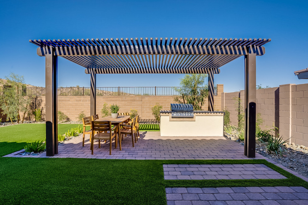 Mid-sized contemporary backyard patio in Phoenix with brick pavers and a pergola.