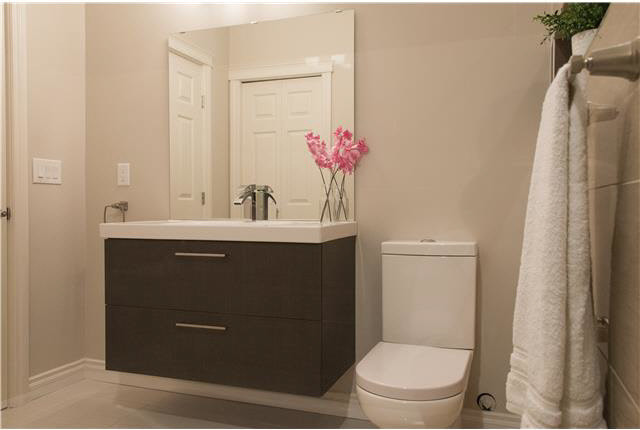 Inspiration for a small modern kids' porcelain tile porcelain tile and brown floor alcove shower remodel in Edmonton with brown cabinets, a two-piece toilet, brown walls and an integrated sink