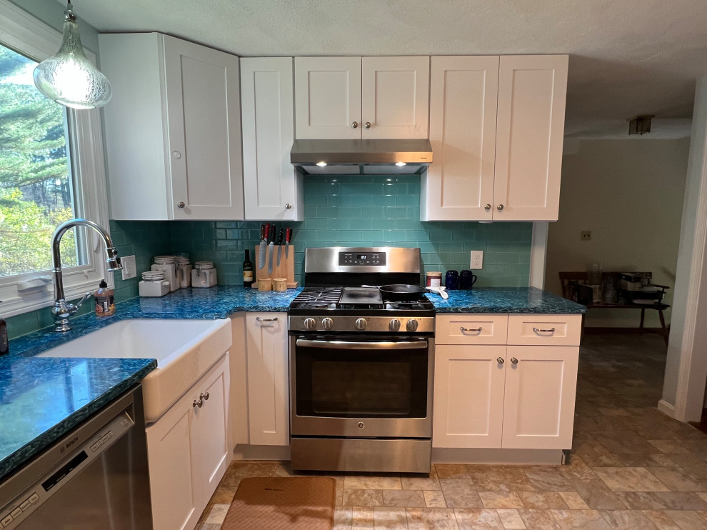Photo of a small transitional l-shaped separate kitchen in Boston with a farmhouse sink, shaker cabinets, white cabinets, quartz benchtops, blue splashback, glass tile splashback, stainless steel appliances, linoleum floors, no island, multi-coloured floor and blue benchtop.