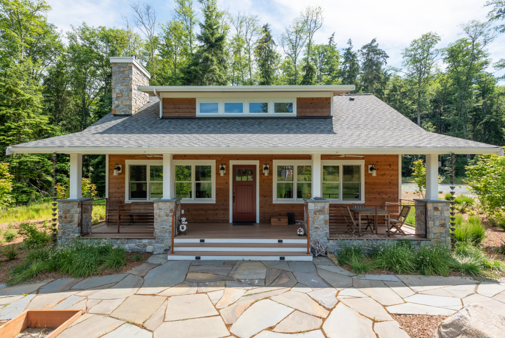 Photo of a small beach style two-storey exterior in Seattle with wood siding, a gable roof, a shingle roof, a grey roof and clapboard siding.