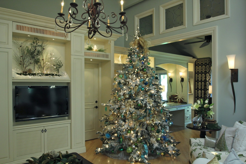 This is an example of a mid-sized traditional open concept living room in San Diego with blue walls, a built-in media wall and light hardwood floors.