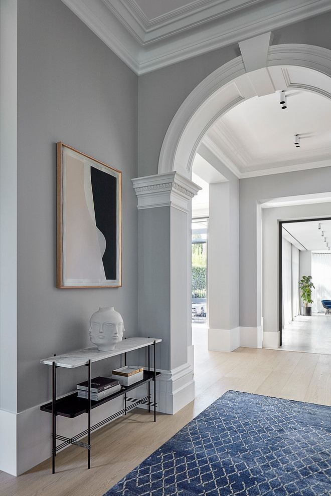 Photo of an expansive modern hallway in Melbourne with grey walls, limestone floors and beige floor.