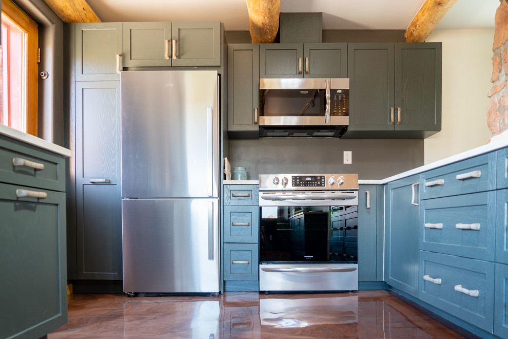 Inspiration for a transitional concrete floor kitchen remodel with shaker cabinets, blue cabinets and stainless steel appliances