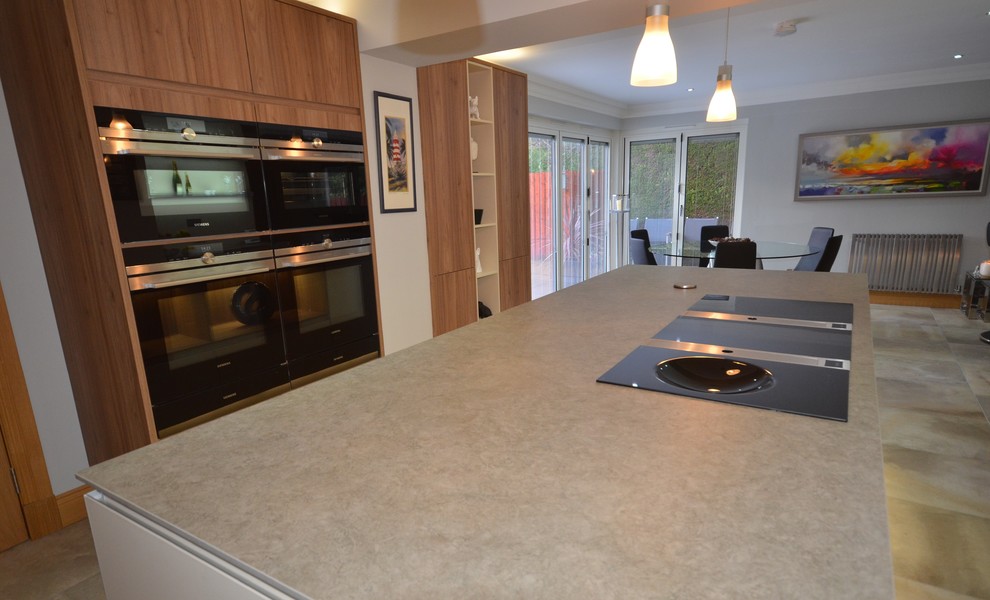 Photo of a mid-sized contemporary u-shaped eat-in kitchen in Other with an integrated sink, panelled appliances, with island, beaded inset cabinets, medium wood cabinets, wood benchtops, brown splashback, marble splashback, ceramic floors and grey floor.