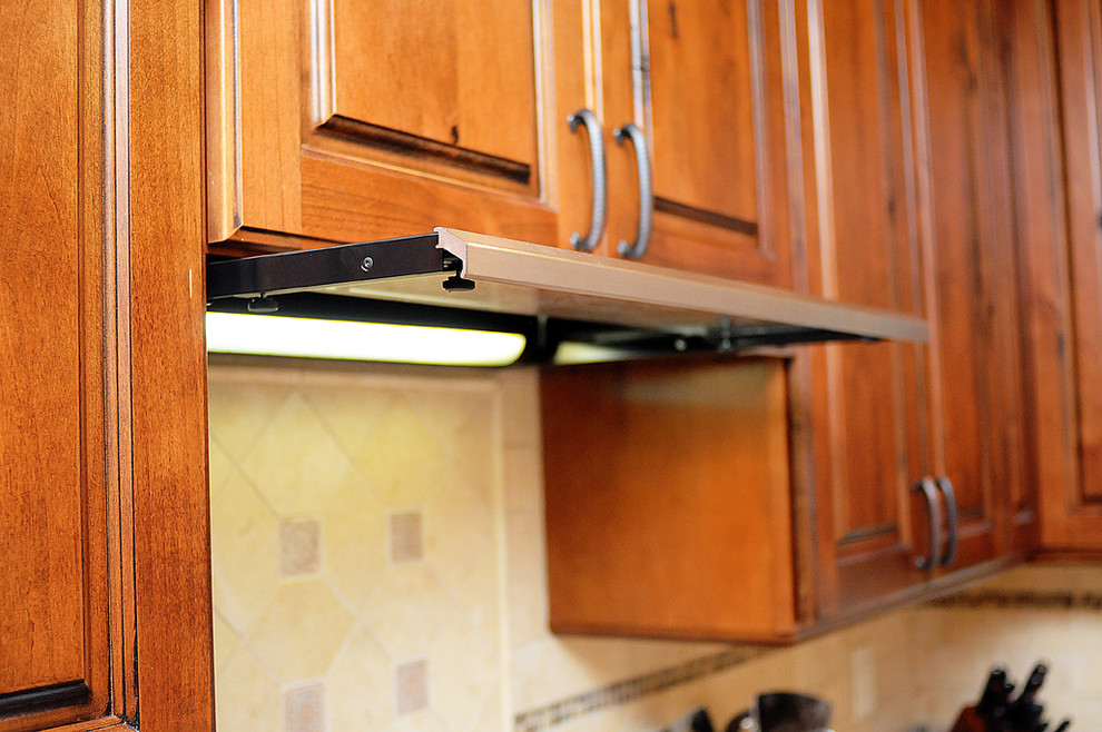 Inspiration for a rustic kitchen remodel in Orlando with raised-panel cabinets, distressed cabinets, granite countertops and stone tile backsplash