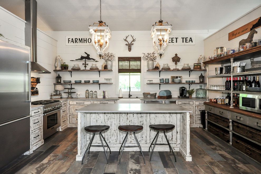 Inspiration for a country kitchen in Atlanta with a farmhouse sink, recessed-panel cabinets, distressed cabinets, white splashback, stainless steel appliances, with island, grey benchtop and multi-coloured floor.