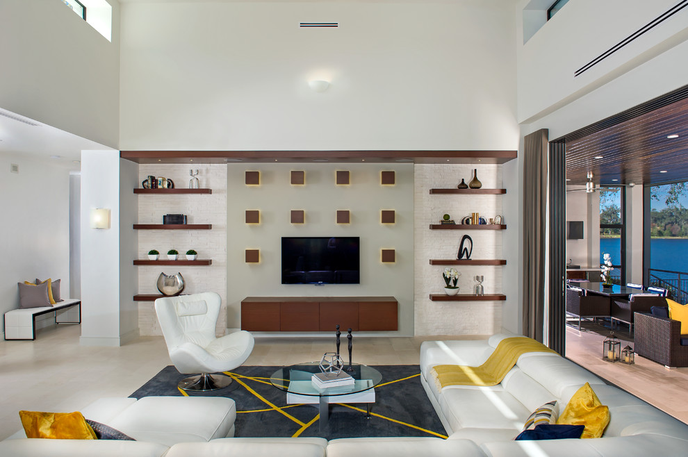 Photo of a large contemporary open concept family room in Orlando with a wall-mounted tv, white walls, porcelain floors and no fireplace.