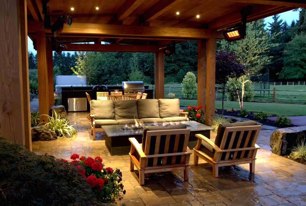 Mid-sized midcentury backyard patio in Seattle with with fireplace, natural stone pavers and a pergola.