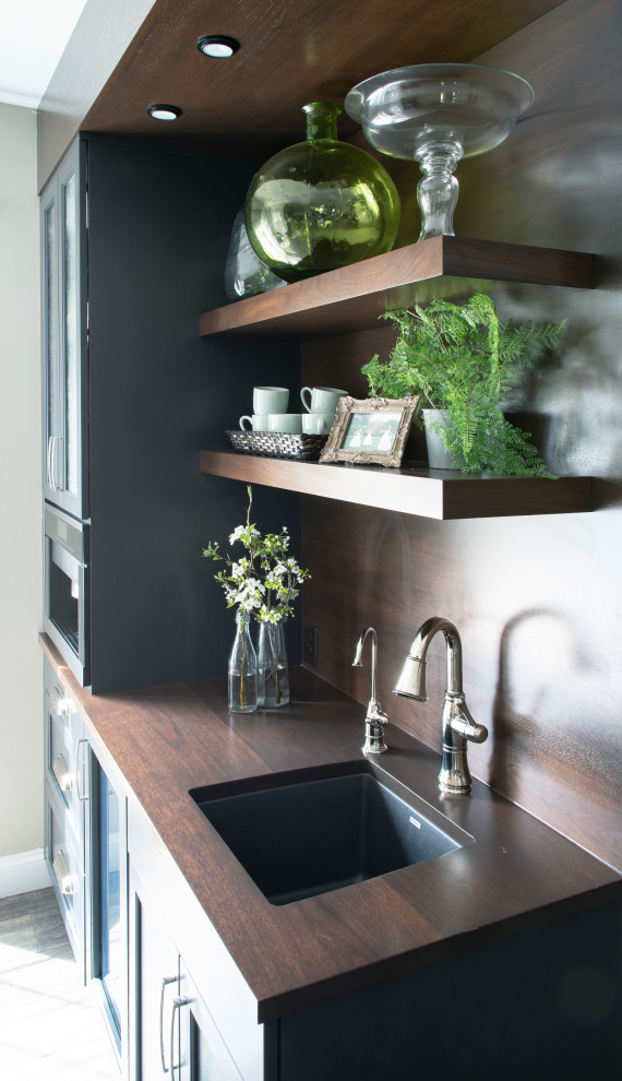 Inspiration for a l-shaped gray floor kitchen remodel with a farmhouse sink, blue cabinets, wood countertops, beige backsplash, ceramic backsplash, stainless steel appliances and an island