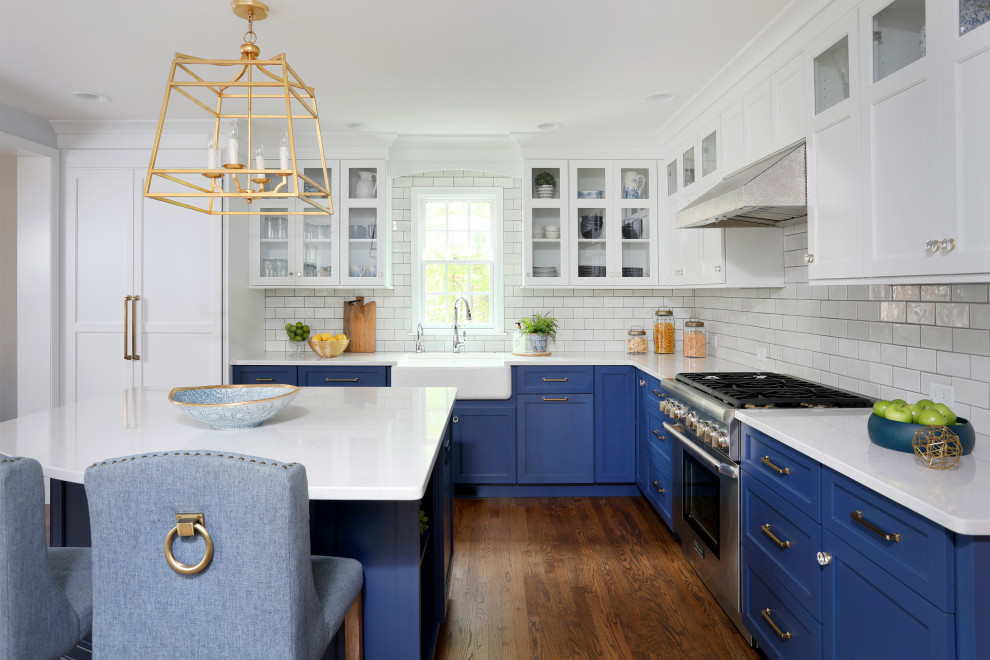 Inspiration for a transitional medium tone wood floor and brown floor eat-in kitchen remodel in Chicago with a farmhouse sink, beaded inset cabinets, blue cabinets, quartz countertops, white backsplash, glass tile backsplash, paneled appliances, an island and white countertops