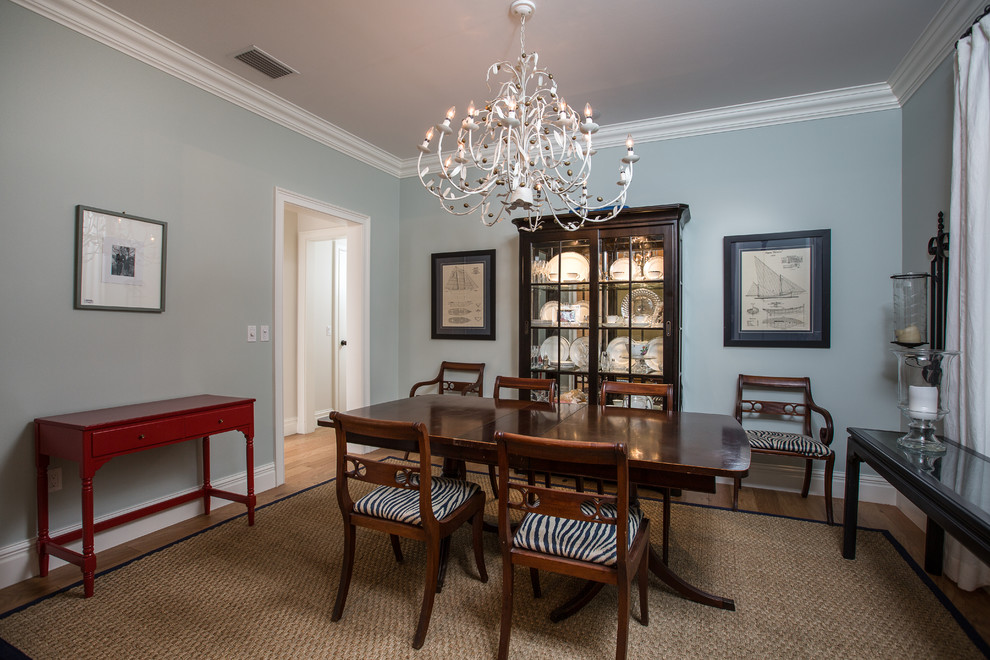 Mid-sized transitional medium tone wood floor enclosed dining room photo in Miami with blue walls and no fireplace