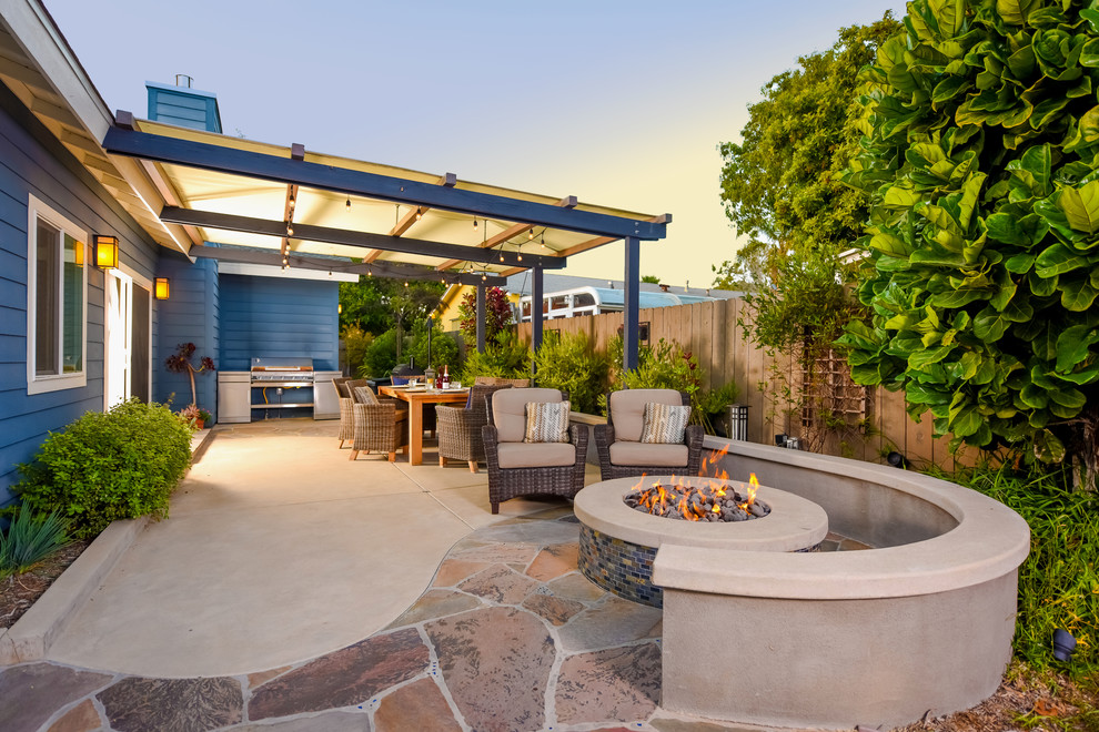 Mid-sized arts and crafts backyard patio in San Diego with natural stone pavers, a fire feature and a pergola.