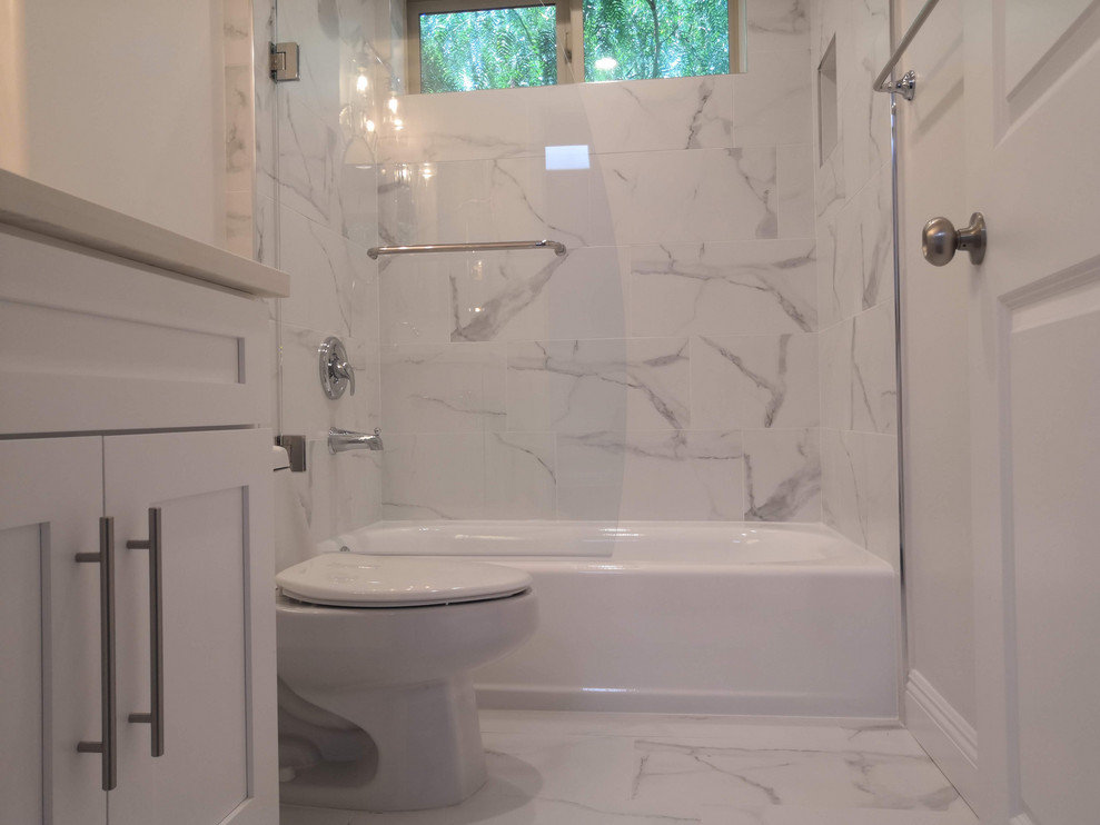 This is an example of a small transitional 3/4 bathroom in Los Angeles with shaker cabinets, white cabinets, an alcove tub, a shower/bathtub combo, a bidet, white walls, porcelain floors, an undermount sink, engineered quartz benchtops, grey floor, an open shower and white benchtops.