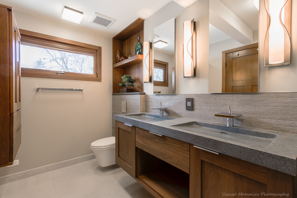Design ideas for a mid-sized contemporary master bathroom in Chicago with an integrated sink, flat-panel cabinets, medium wood cabinets, an alcove shower, a wall-mount toilet, gray tile, porcelain tile, grey walls, porcelain floors, engineered quartz benchtops, beige floor and an open shower.