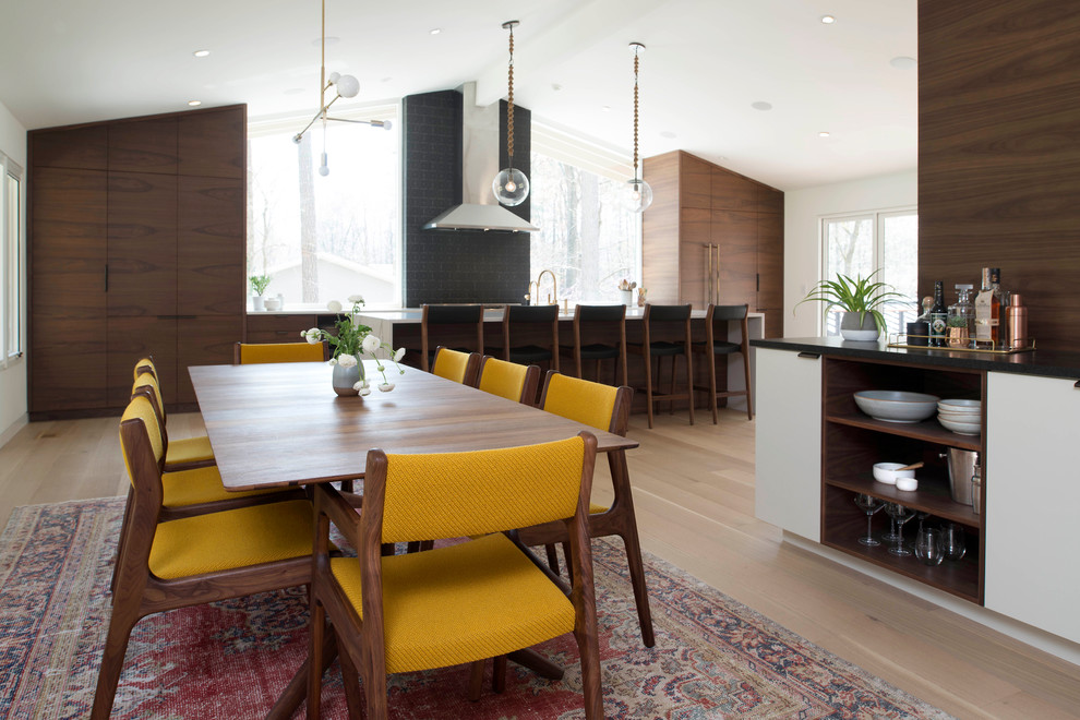 1960s light wood floor dining room photo in Raleigh with white walls