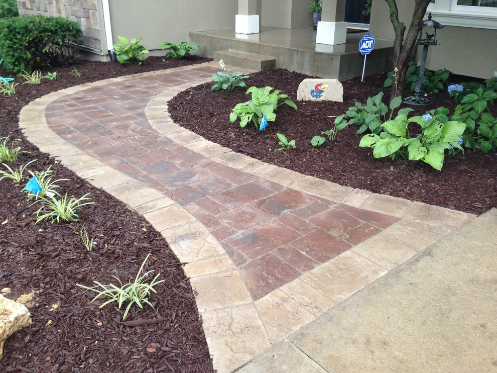 Photo of a large traditional front yard garden in Other with a garden path and natural stone pavers.