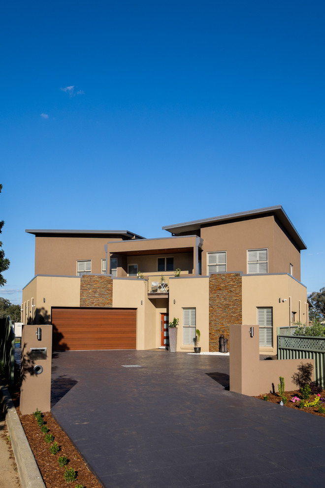 Photo of a large contemporary two-storey exterior in Newcastle - Maitland.