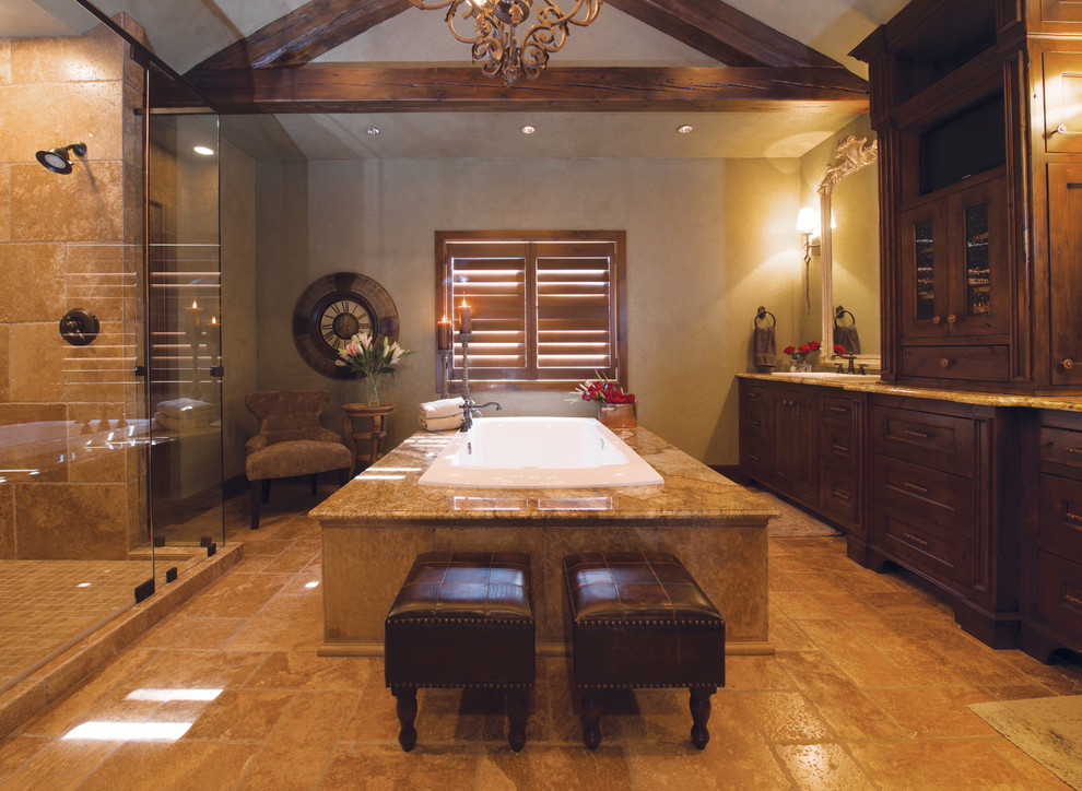 Huge mountain style master beige tile and ceramic tile ceramic tile drop-in bathtub photo with beaded inset cabinets, dark wood cabinets, beige walls, a drop-in sink and granite countertops