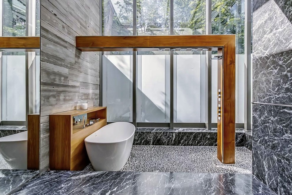 Photo of a large scandinavian master bathroom in Toronto with a freestanding tub, an open shower, black and white tile, stone tile, black walls, marble floors, grey floor and an open shower.