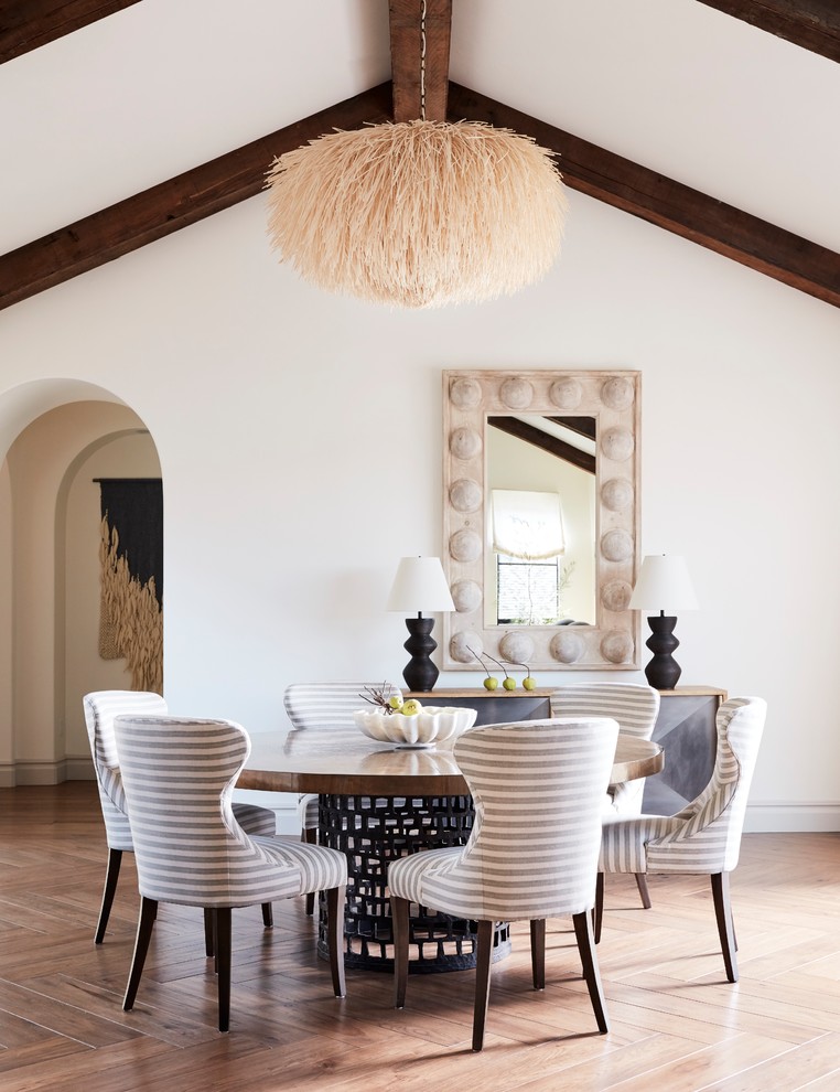 This is an example of a country dining room in San Francisco with white walls, medium hardwood floors and brown floor.