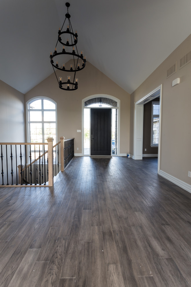 Hallway - large transitional medium tone wood floor and brown floor hallway idea in Toronto with brown walls