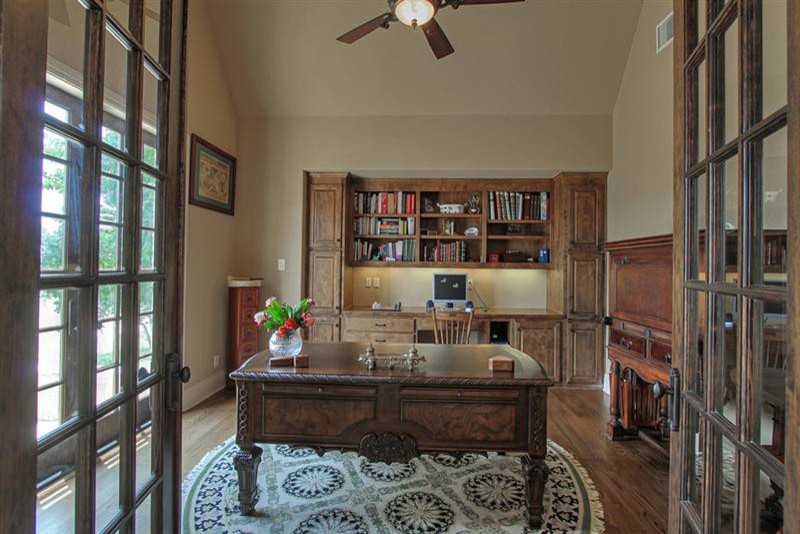 Inspiration for a mid-sized traditional study room in Austin with beige walls, travertine floors, no fireplace and a freestanding desk.