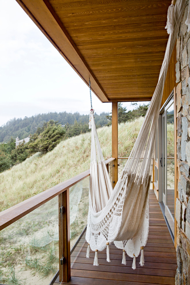 Inspiration for a beach style balcony in Portland with a roof extension.
